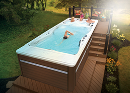 Couple relaxing watching a movie on their ipad in the h2x swimspa
